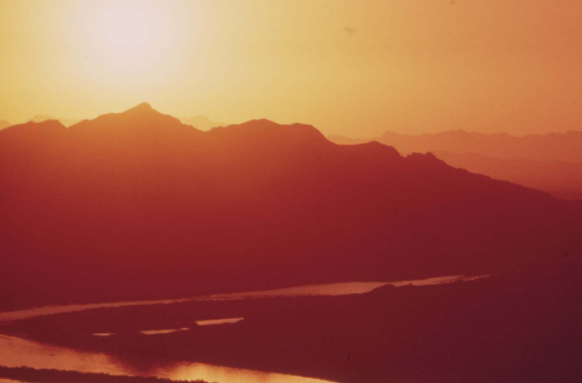 The Colorado River at sunrise north of Yuma, with desert mountains on the horizon.